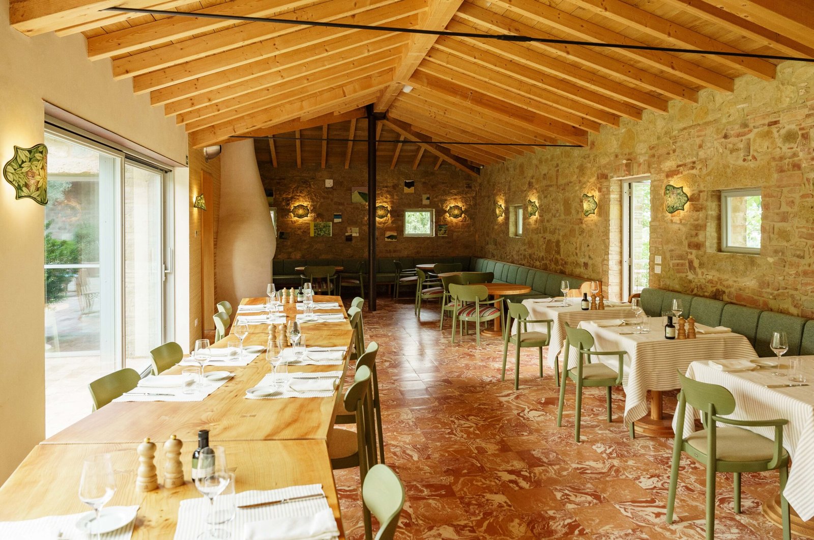 Restaurant dining room with beamed ceiling and laid tables in a winery