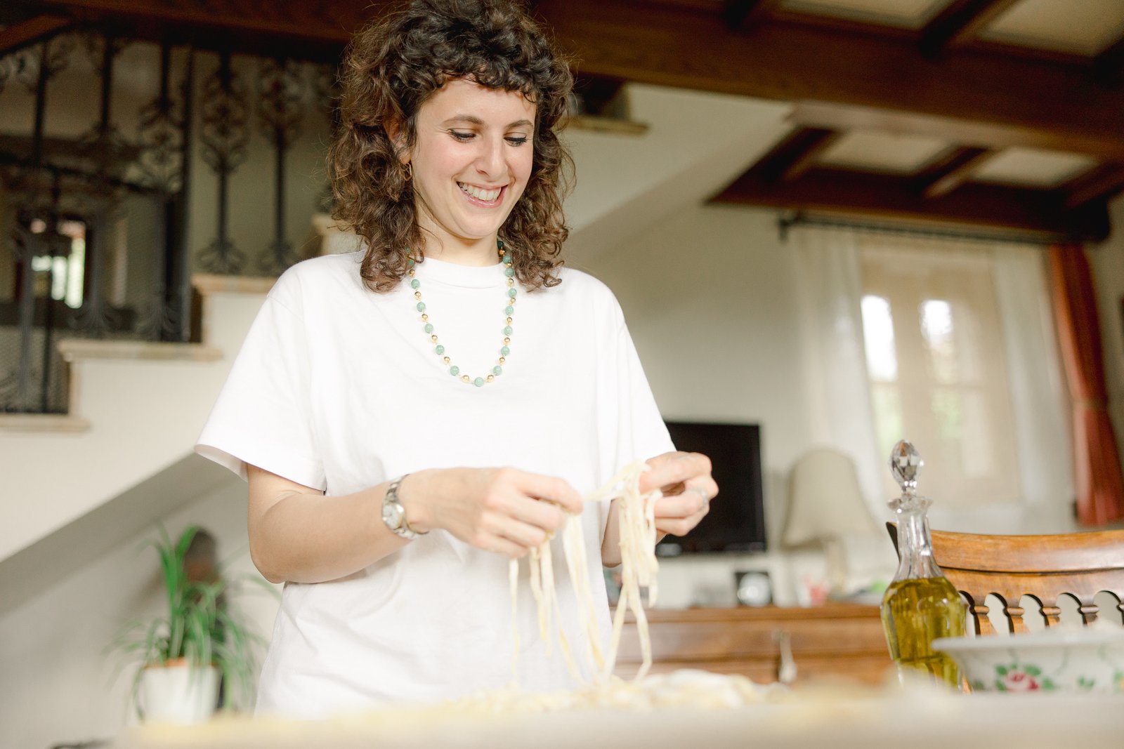 Woman making fresh pasta by hand in the kitchen of a Tuscan villa near Cortona