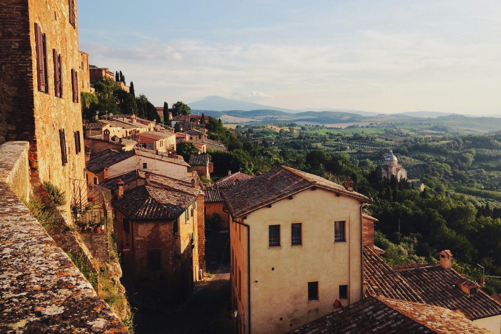 Stone farmhouse on a rolling golden hill in the Tuscan countryside Stone farmhouse on a rolling golden hill in the Tuscan countryside
