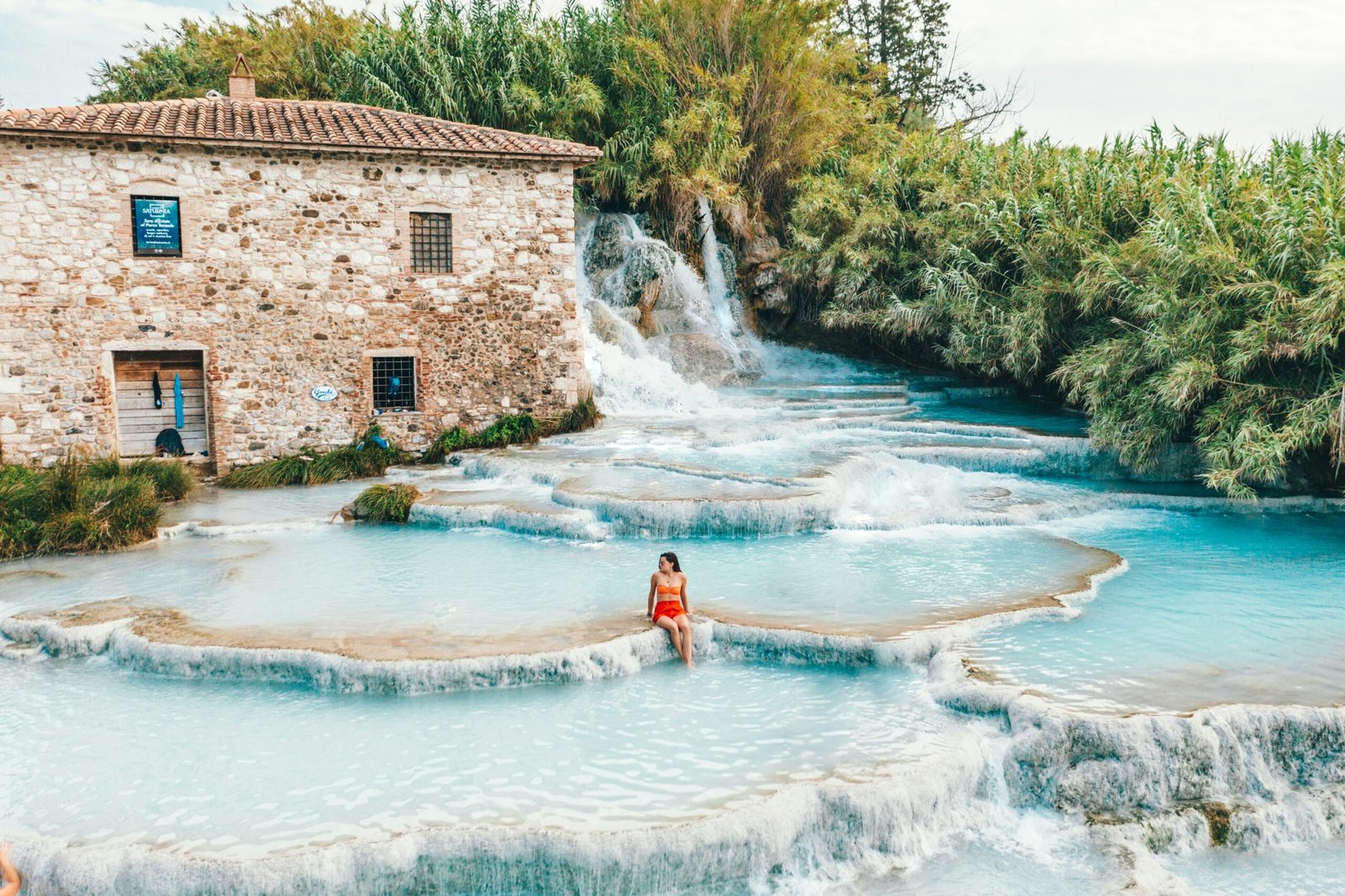 Thermal cascades of the Saturnia hot springs beside an old stone mill in southern Tuscany