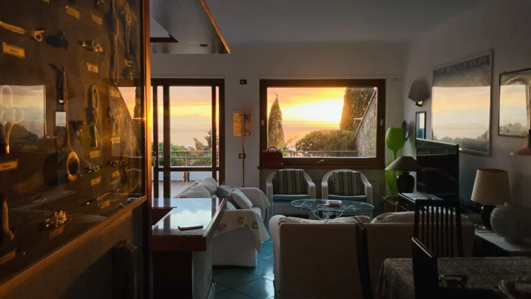 Villa Monte Bianco – Living room at sunset Two armchairs on the terrace of Villa Monte Bianco looking over pines and cypresses to the Tyrrhenian Sea