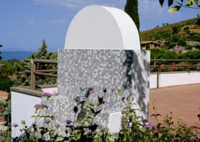 Mosaic outdoor shower on the terrace of Villa Monte Bianco with a view of the sea and the hills