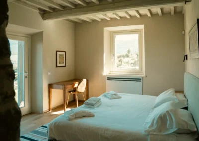 Bedroom with window onto the Tuscan countryside at Villa Santa Maria Nuova, Cortona