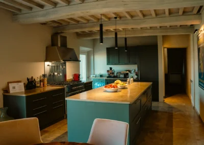 Kitchen with island and wooden-beam ceiling at Villa Santa Maria Nuova, Cortona