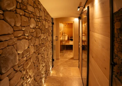 Spa area with sauna and exposed stone wall at Villa Santa Maria Nuova, Cortona