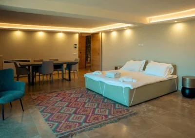 Spacious bedroom suite with ambient ceiling lighting and dining table at Villa Santa Maria Nuova, Cortona