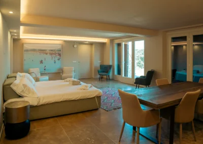 Large suite with double bed, dining table and garden doors at Villa Santa Maria Nuova, Cortona