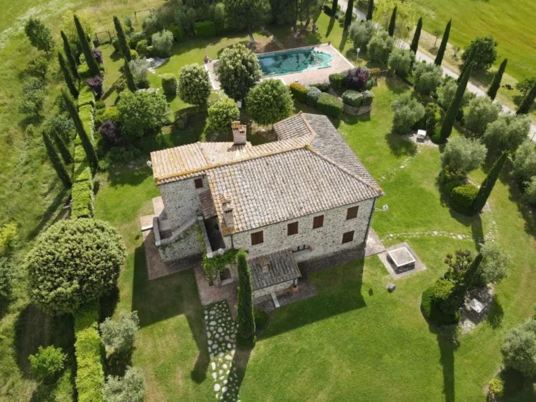 Aerial view of the stone villa with garden, cypresses and private pool Aerial view of the stone villa with garden, cypresses and private pool