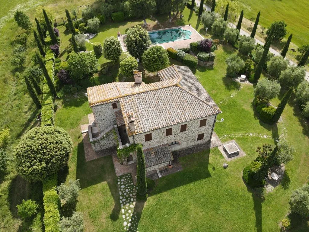 Aerial view of the stone villa with garden, cypresses and private pool